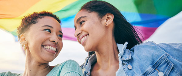 two women with a pride flag